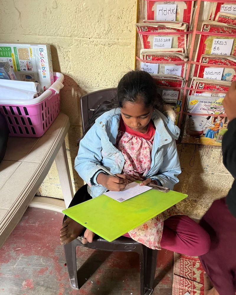 A girl writing a letter at the Learning with Postmaster session